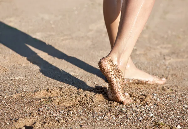 stock image Legs on the sand beach