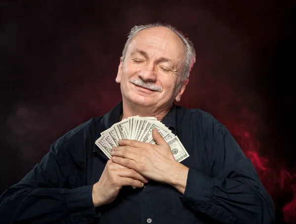 Old man holding dollar bills — Stock Photo, Image