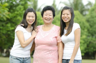 Asian mother with two of her daughters clipart