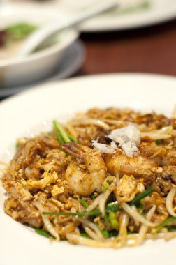 Fried Penang Char Kuey Teow which is a popular noodle dish in Ma clipart