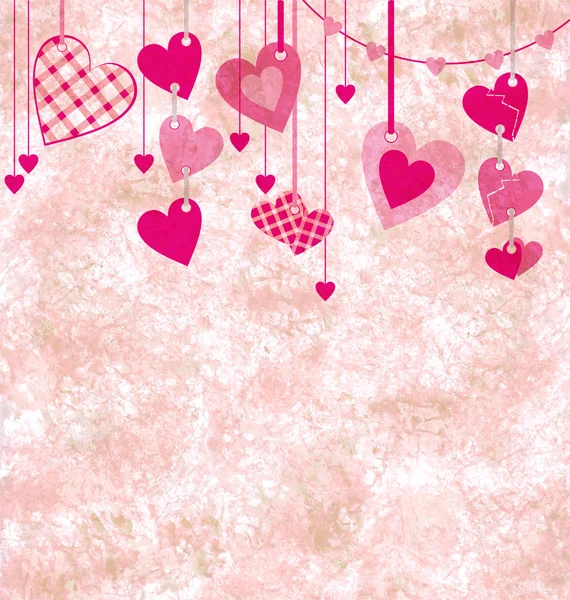 Different pink hanging hearts on the grunge light paper backgrou — Stock Photo, Image