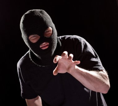 Aggressive burglar in black mask clipart