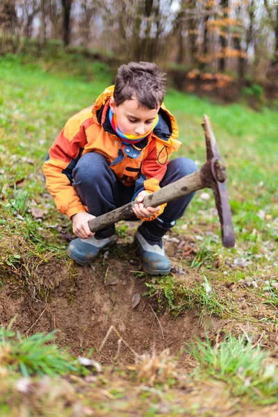 Pojken gräva i marken — Stockfoto
