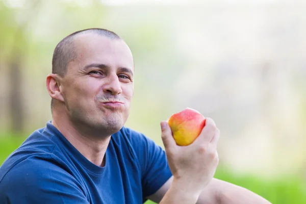 Mann isst einen Apfel im Freien — Stockfoto