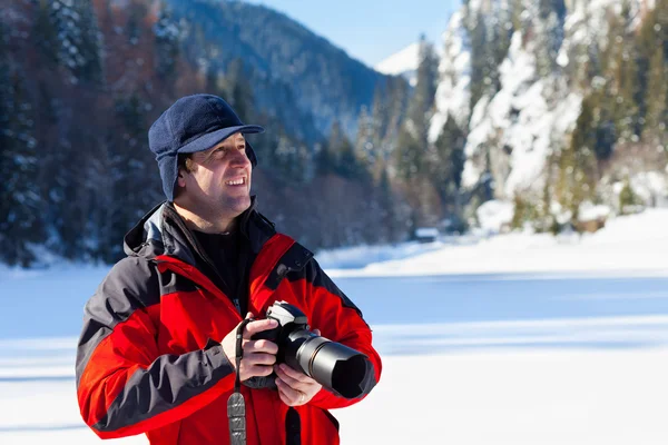 Professional photographer in the winter landscape Royalty Free Stock Photos