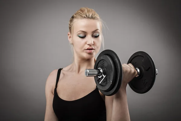 Athletic young lady working out with weights Stock Image
