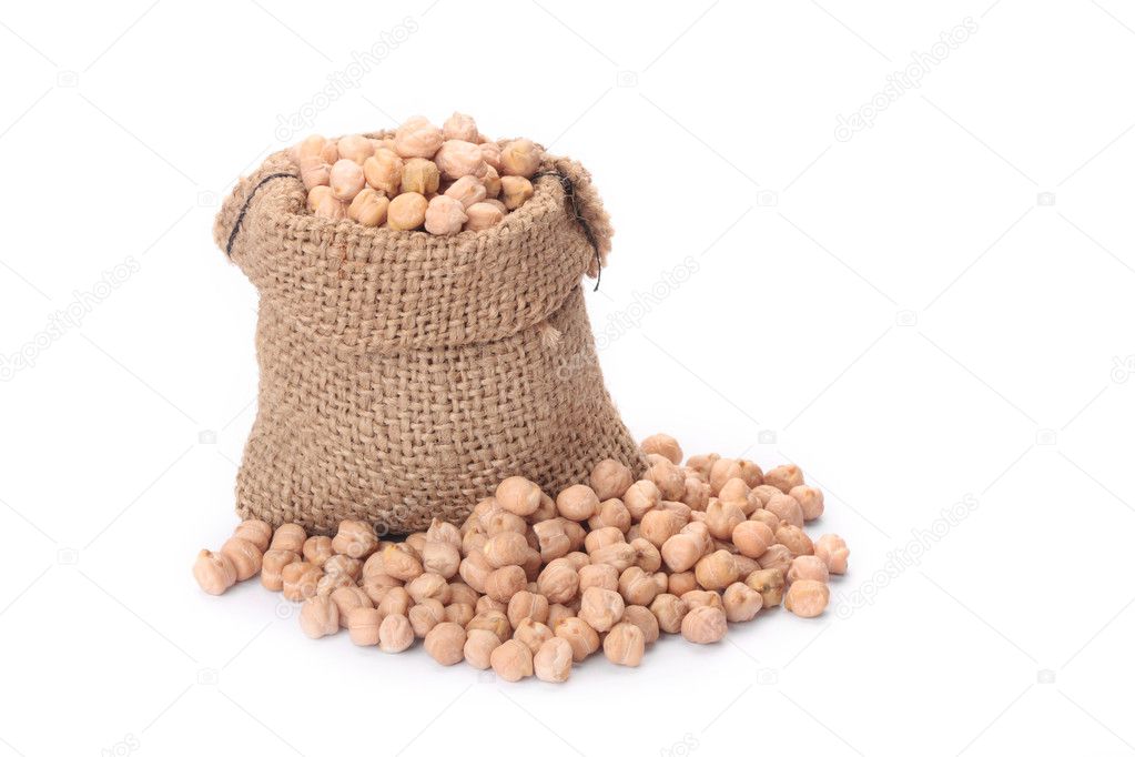 Burlap sack with chickpeas spilling out over a white