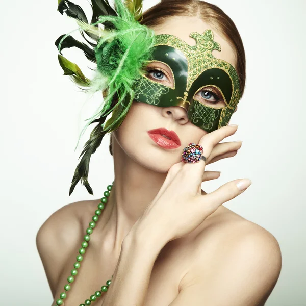 The beautiful young woman in a green mysterious venetian mask — Stock Photo, Image