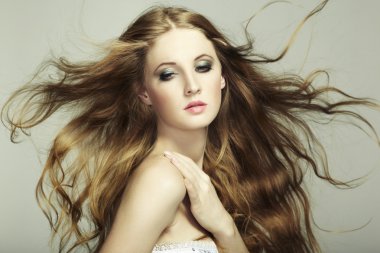 Portrait of young beautiful woman with long flowing hair clipart