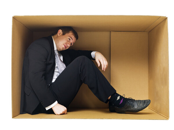 Businessman in a tight cardboard