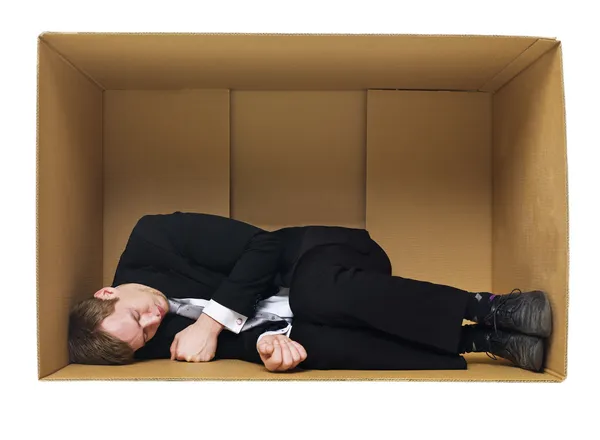 Sleeping in a cardboard box — Stockfoto