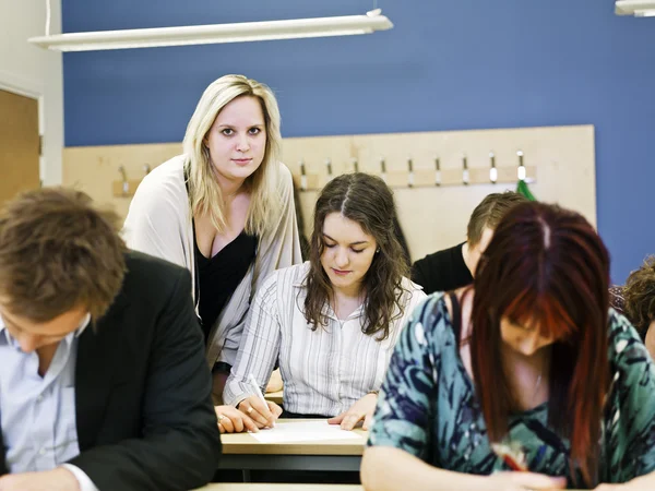 Teacher and young students — Stock Photo, Image
