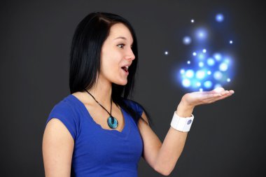 Amazed young woman holding magical lights clipart