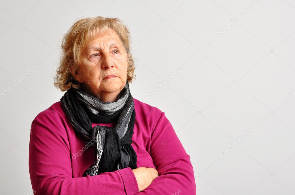 Senior woman in pink with crossed arms
