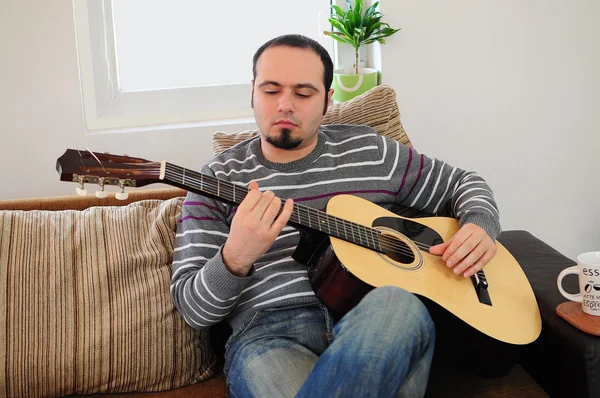 stock image Young man playing the guitar