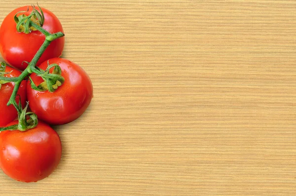 Branch tomatoes on wooden board — Stock Photo, Image