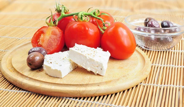 Fresh tomatoes, olives and white cheese — Stock Photo, Image