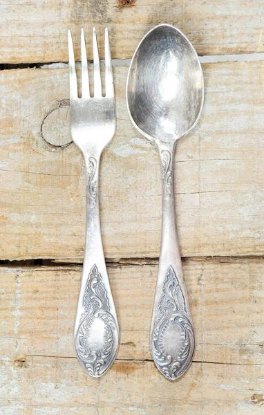 Vintage silver fork and spoon on wooden background — Stock Photo, Image