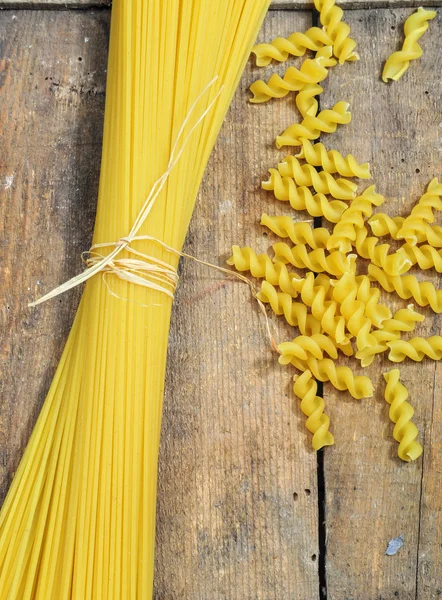 Raw pasta on wooden background — Stock Photo, Image
