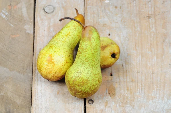 Three pears on wooden background — Stock Photo, Image