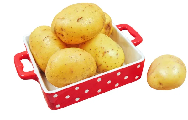Raw potatoes in red tray, isolated — Stock Photo, Image
