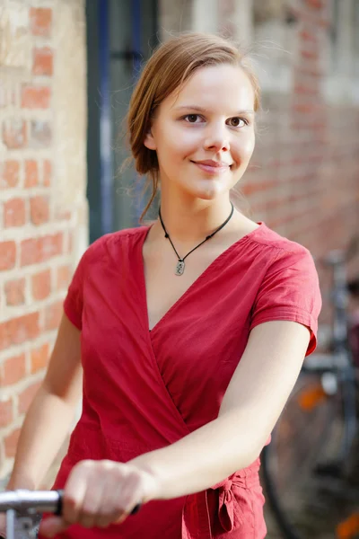 Pretty young woman with bicycle — Stock Photo, Image
