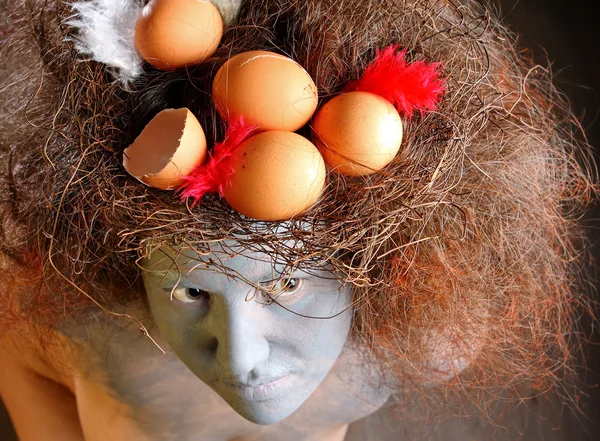 Woman with a nest in hair — Stock Photo, Image