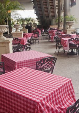 Patio Tables with Red Checkboard Tablecloths clipart