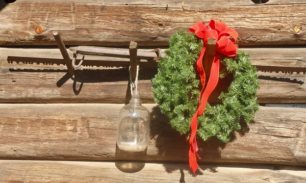 Christmas Wreath on Old Barn with Saw — Stock Photo, Image