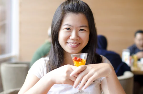 Asian woman enjoying her dessert — Stock Photo, Image