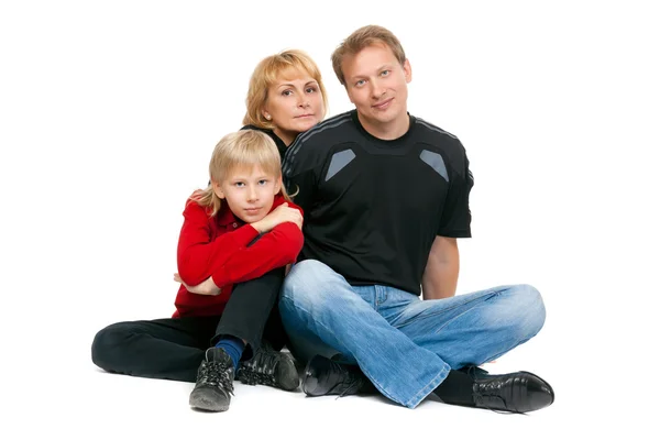 Familia feliz sentada en la posición de loto — Foto de Stock