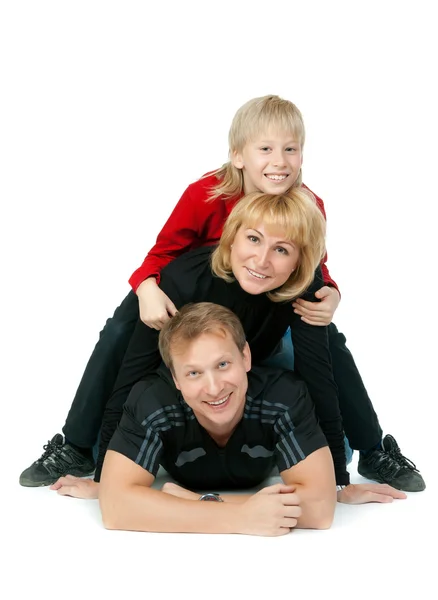 Šťastná rodina, ležící na podlaze — Stock fotografie