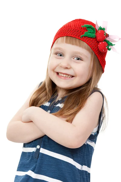 Vacker liten flicka i en röd hatt med ett mönster av strawberrie — Stockfoto