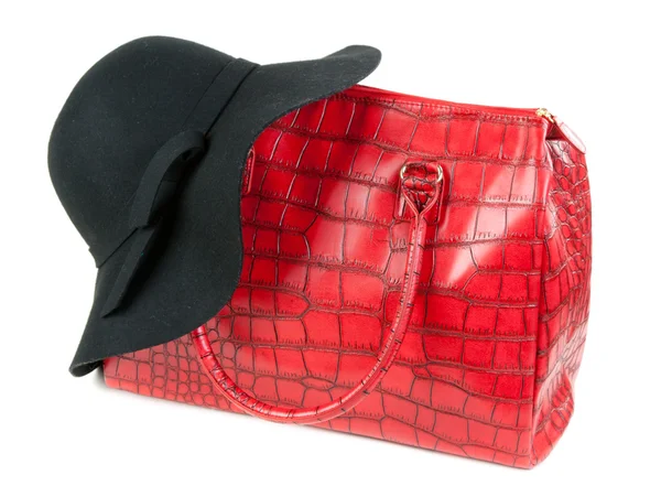 Red Fashion ladies handbag and a black felt hat — Stok fotoğraf
