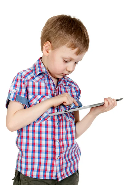 A boy in a plaid shirt with a tablet computer — Stock Photo, Image