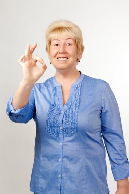 Middle-aged woman shows OK clipart