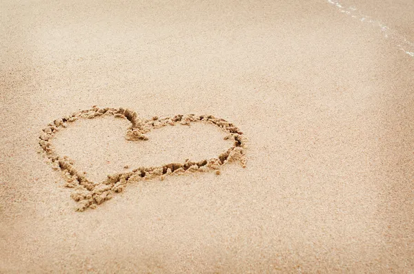 The heart drawn on the sand in beach Stock Image