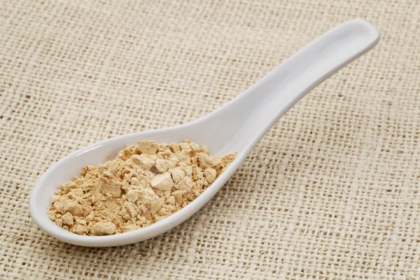 Maca root powder on a ceramic spoon — Stock Photo, Image