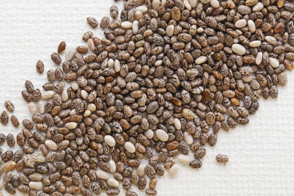 Chia seeds on white canvas — Stock Photo, Image