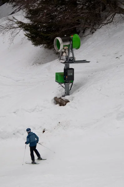 Snowgun and skier — Stock Photo, Image