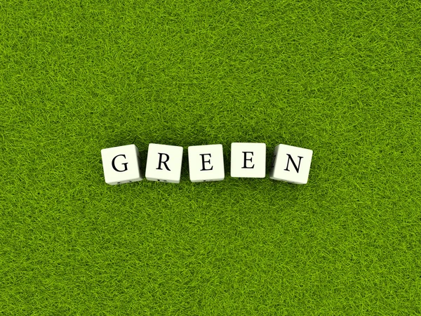 Green sign on blocks over green grass — Stock Photo, Image