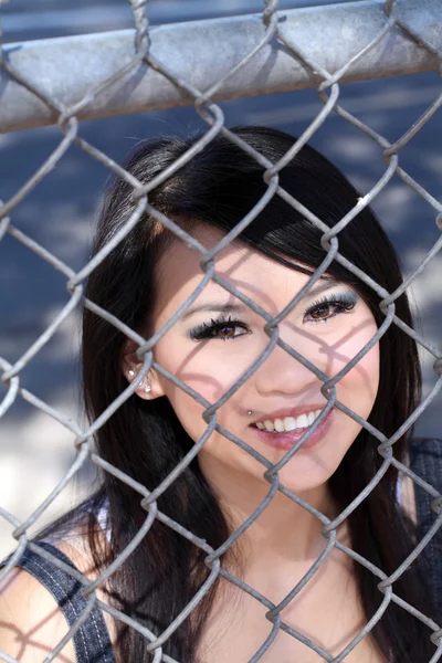 Lachende portret Aziatische Amerikaanse vrouw ketting hek — Stockfoto