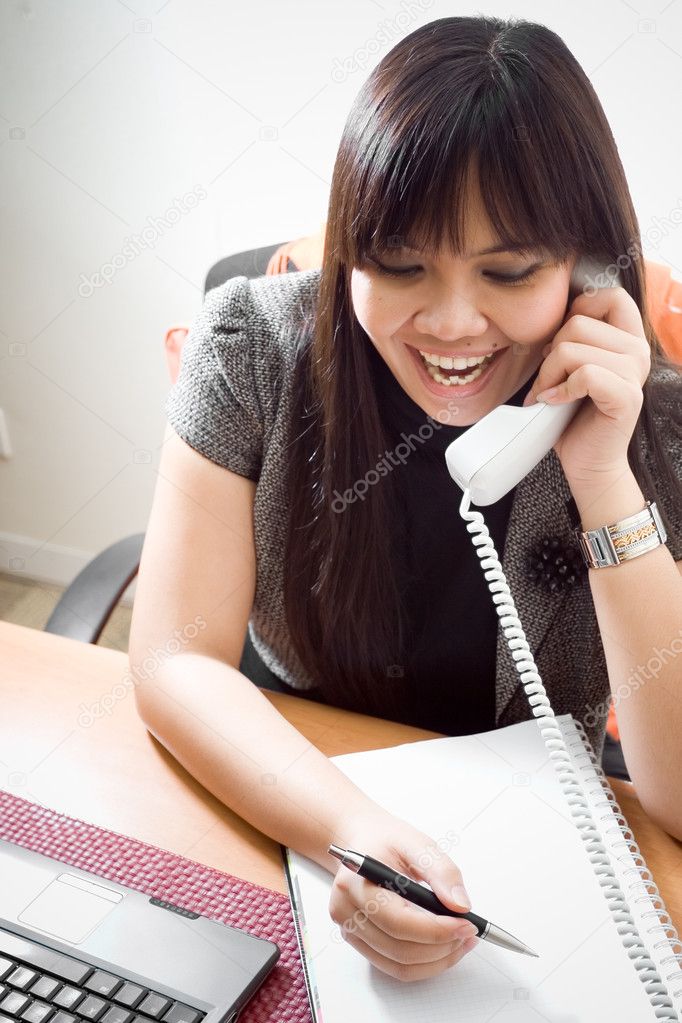 Business woman on the phone with customer