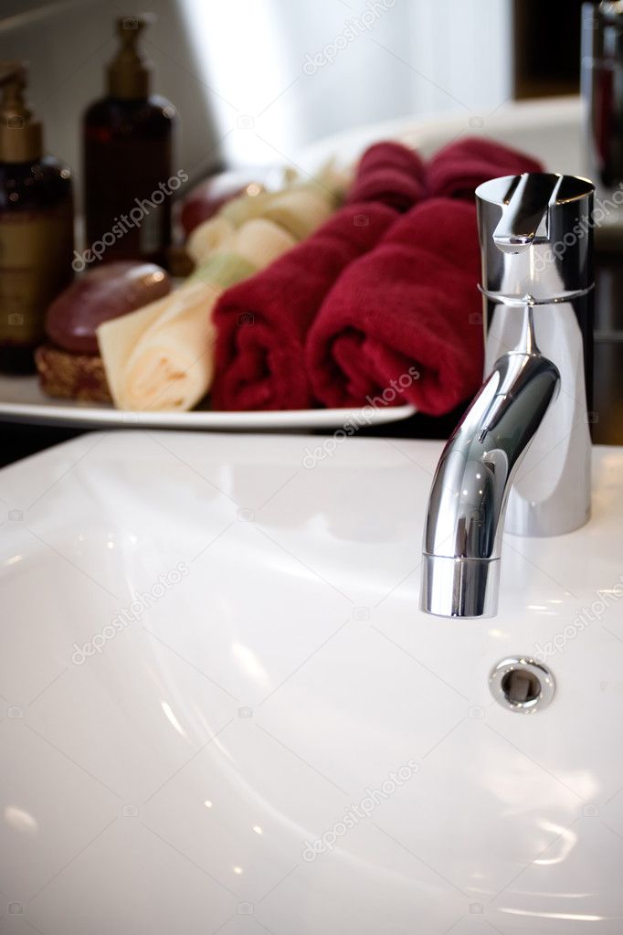 Clean and modern washbasin with bathing supplies