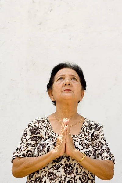 Ethnic senior woman praying — Stock Photo, Image