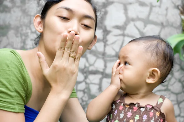 Etik mor lär baby flicka en adjö kyss — Stockfoto