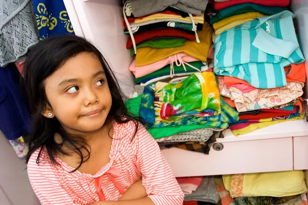 Little girl and her clothing collection — Stock Photo, Image