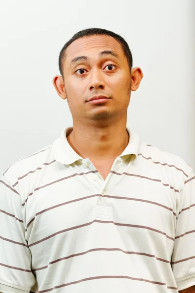 Asian young man with questioning face expression — Stock Photo, Image