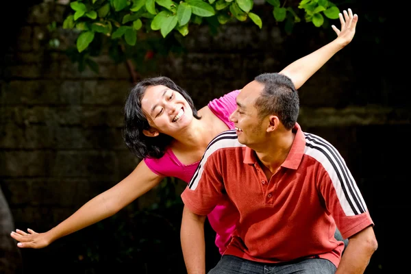 Happy ethnic couple play together — Stock Photo, Image