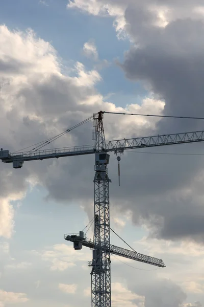 Cloudy sky with two cranes — Stock Photo, Image